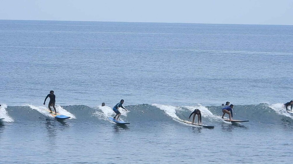 Surfers riding waves in the ocean. 3