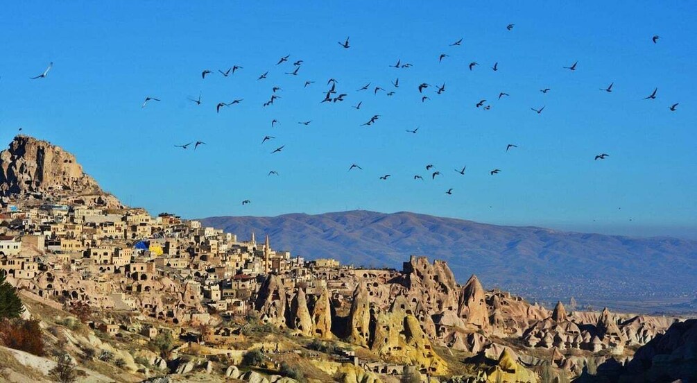 A town nestled in a mountainous area with unique rock formations. 5