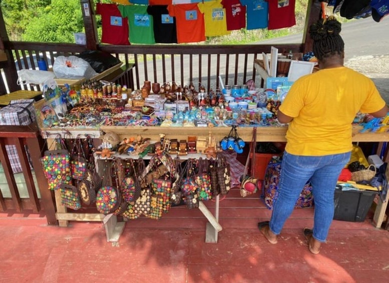 A stall with various items including jewelry, bags, and colorful clothing. 3