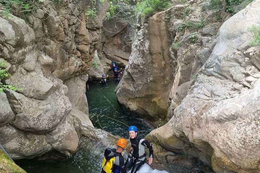 A canyon with rocky walls and a narrow water channel. 2