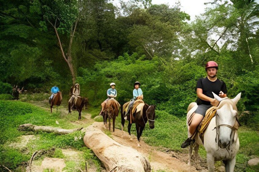 A group of people riding horses on a dirt path through a forested area. 5