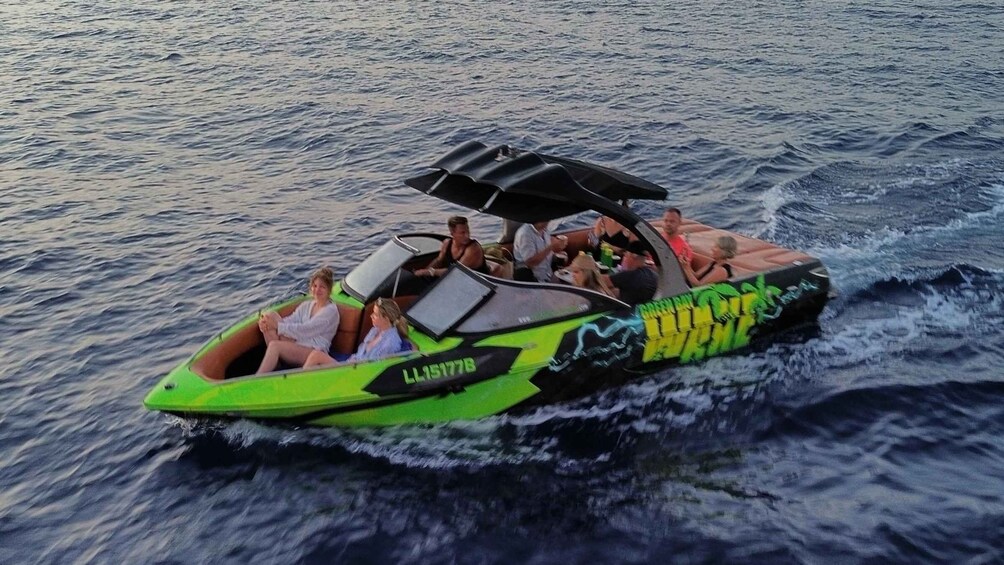 A green jet ski with a canopy on the water. 5
