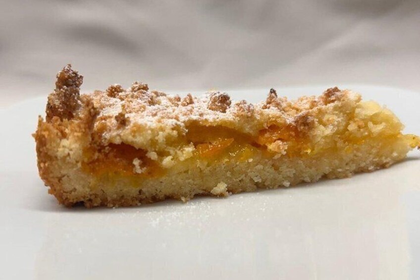 A slice of fruitcake with a crumbly topping. 4