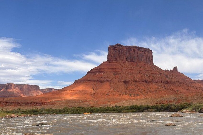 A river flowing through a canyon with a prominent red rock formation. 2