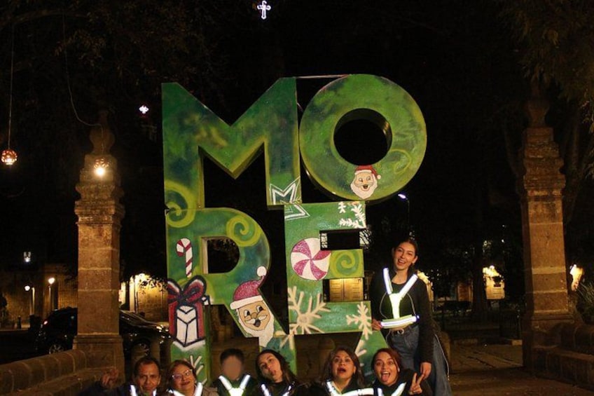 A large illuminated sign with the letters 'MOM' and various decorations. 5