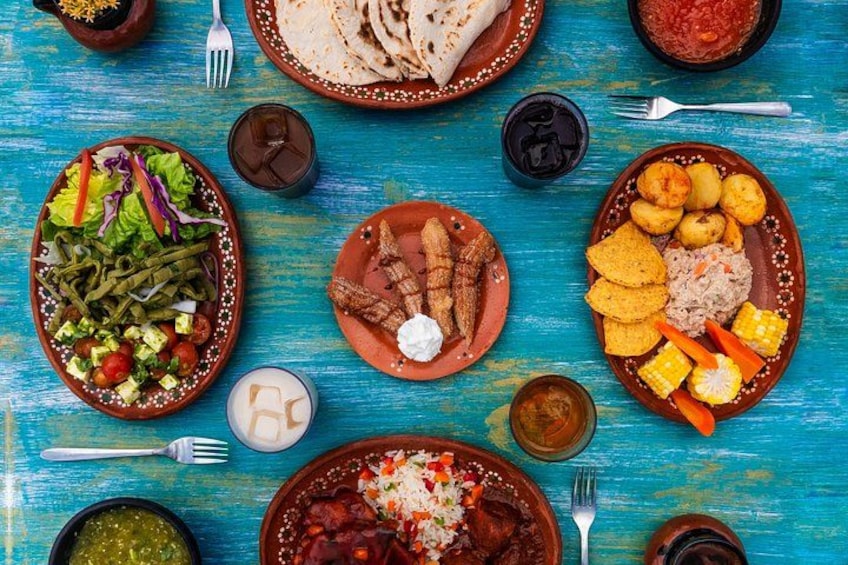 A colorful array of traditional dishes on a blue wooden table. 5