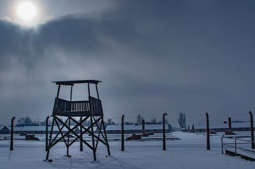 A wooden observation tower in a snowy landscape with a clear sky. 1