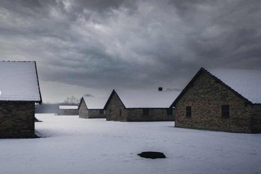 A snow-covered farm with stone buildings and a cloudy sky. 3