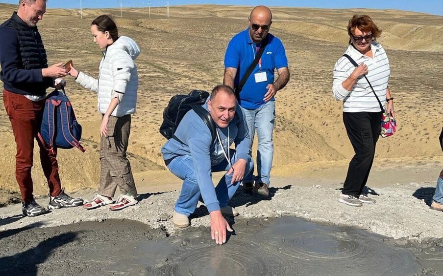 A group of people observing a geological formation. 2