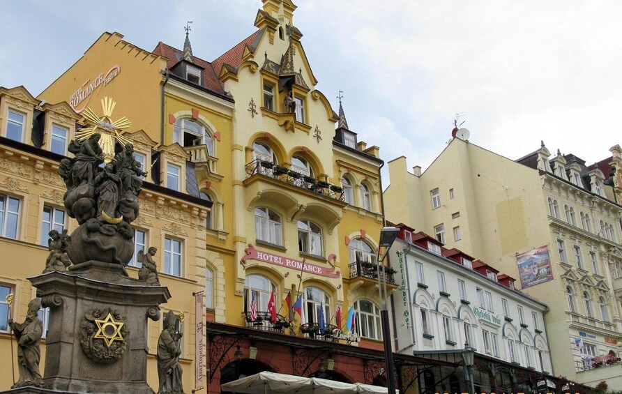 A yellow building with a sign for 'Hotel Romance.' 1