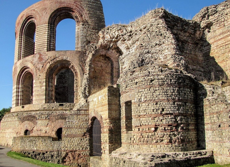 An ancient stone structure with arches and a circular tower. 4