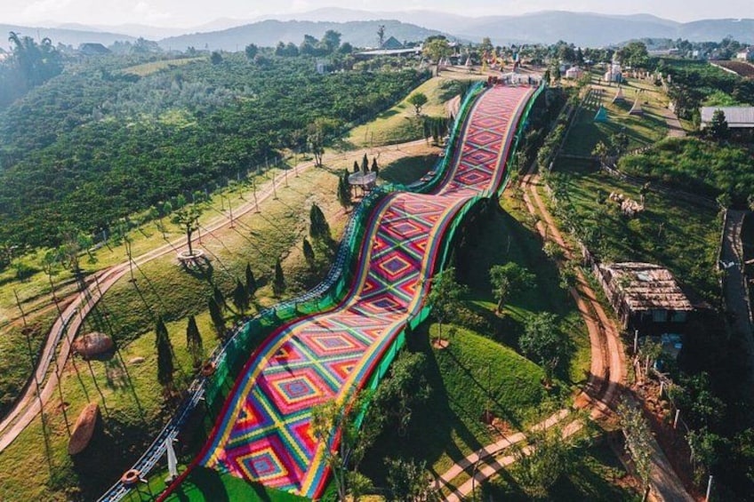 Un pont piétonnier aux couleurs vives, situé dans un paysage vallonné. 5