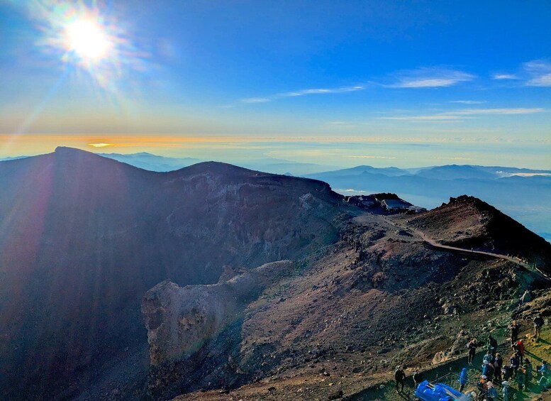 A mountainous landscape with a clear sky and the sun shining. 4
