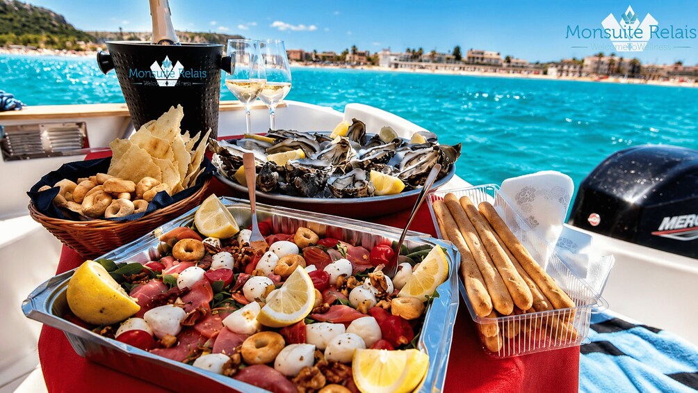 A boat with a table set with seafood, bread, and a bucket of oysters. 3