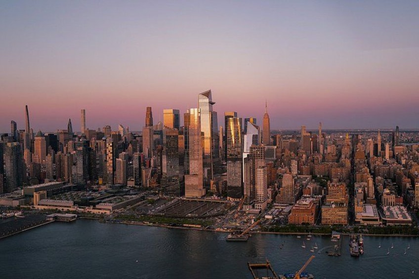 A city skyline with high-rise buildings, a body of water, and boats. 4