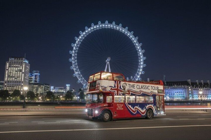 A double-decker bus with 'The Classic Tour' written on the side, driving on a road with a large Ferris wheel in the background. 1