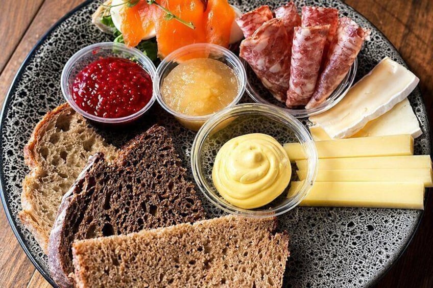 En tallerken med forskelligt mad, blandt andet brød, ost og kød. 1