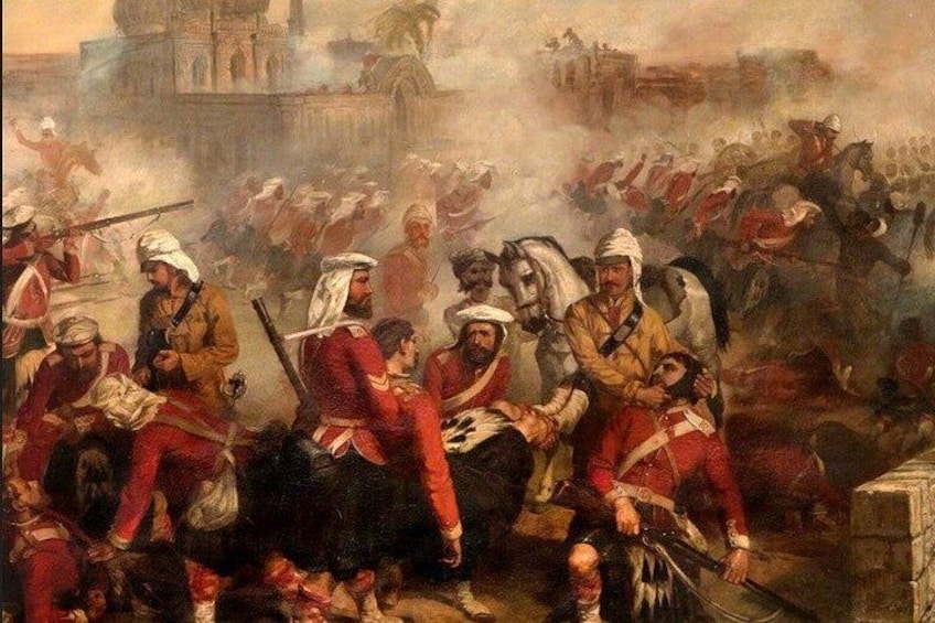 A historical battle scene with soldiers in red uniforms, some on horseback, and a large building in the background. 1