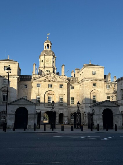 A historic building with a prominent clock tower, arched entrances, and classical architecture. 5