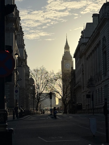A street with buildings, a clock tower, and a sign indicating a controlled zone. 1