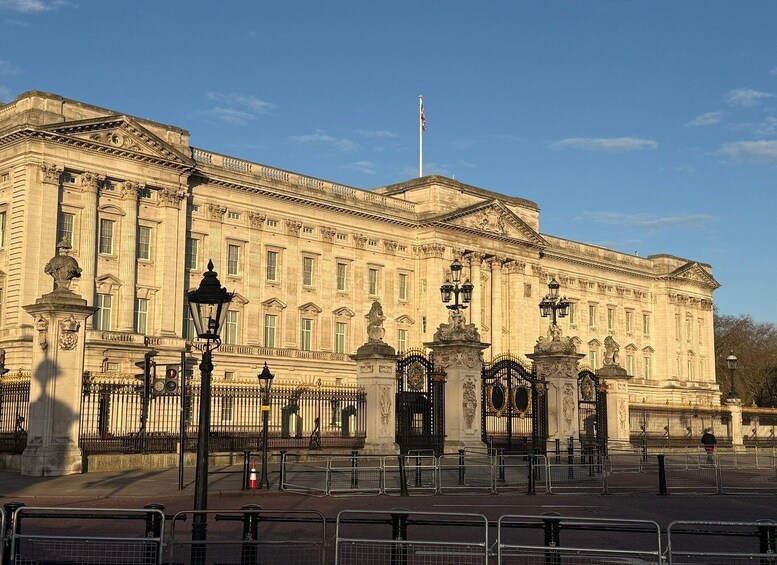 A large, ornate building with classical architecture, featuring columns, statues, and a flagpole. 2