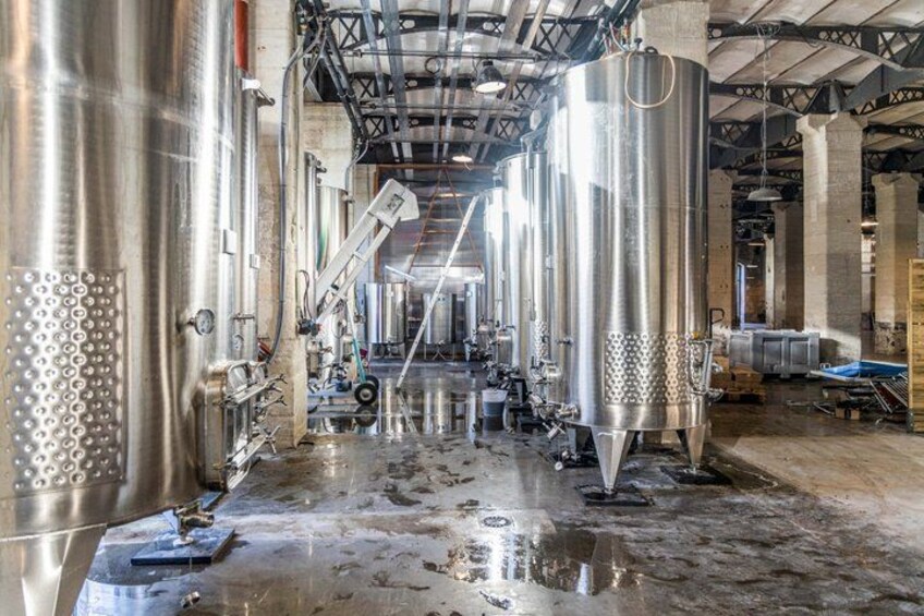 A large industrial facility with stainless steel tanks and equipment. 5