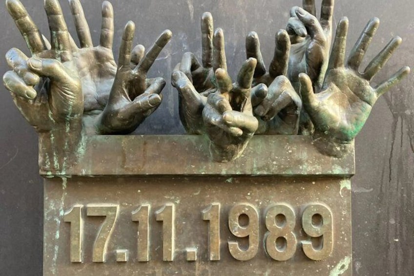 A sculpture of hands with the date '17.11.1989' below. 4