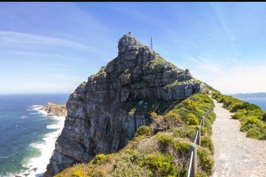 A coastal cliff with a narrow path leading to a viewpoint. 3