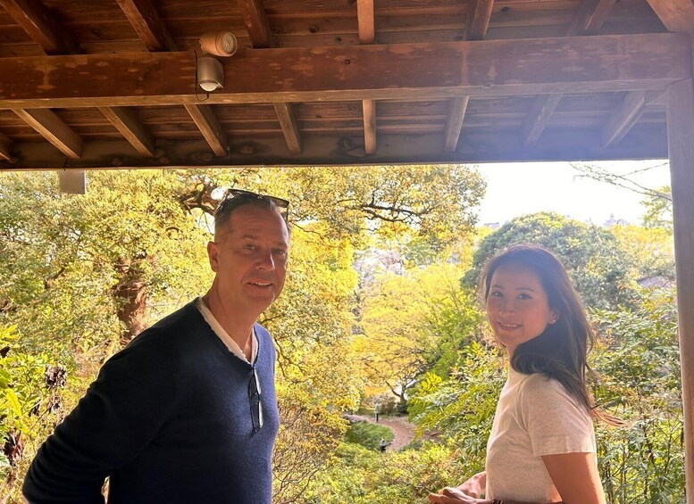 A wooden structure with a person and a woman standing in a garden with trees. 4
