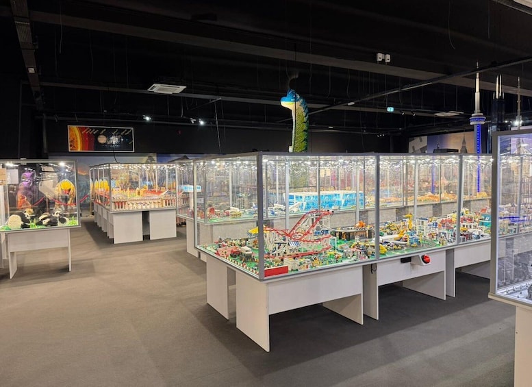 A display of various model train sets and structures in glass cases. 4
