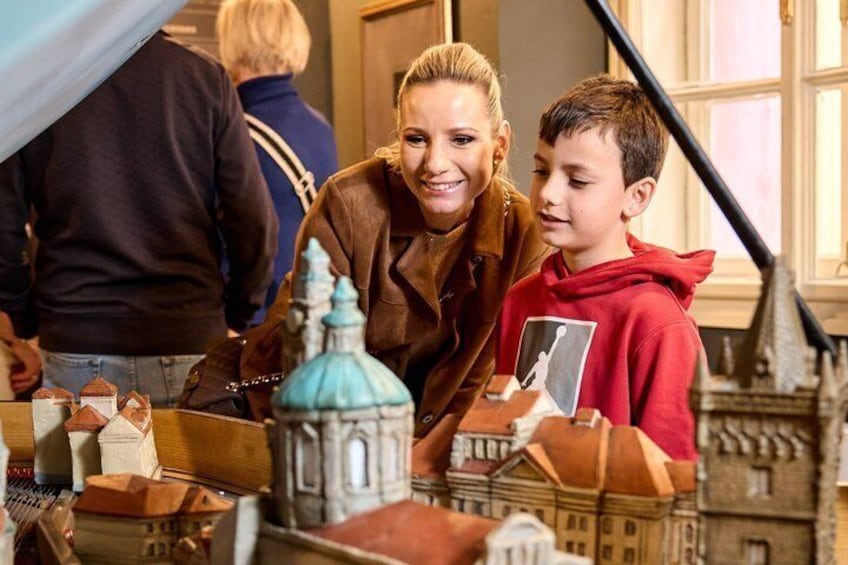 A model train setup with miniature buildings and a blue-domed structure. 2
