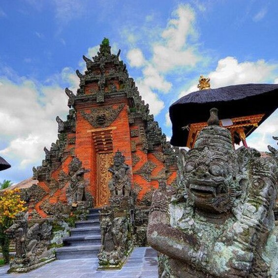 A traditional Balinese temple with ornate carvings and a central deity statue. 2