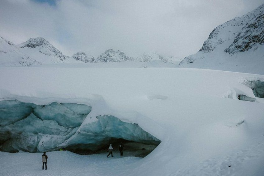 A snowy landscape with ice formations and mountains in the background. 4