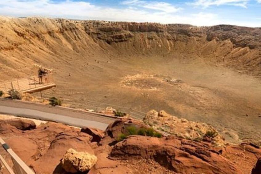 A winding road through a rocky canyon with a wooden viewing platform. 2