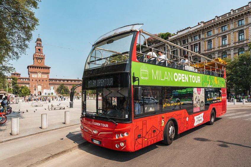A red double-decker bus with 'MILAN OPEN TOUR' written on it. 1