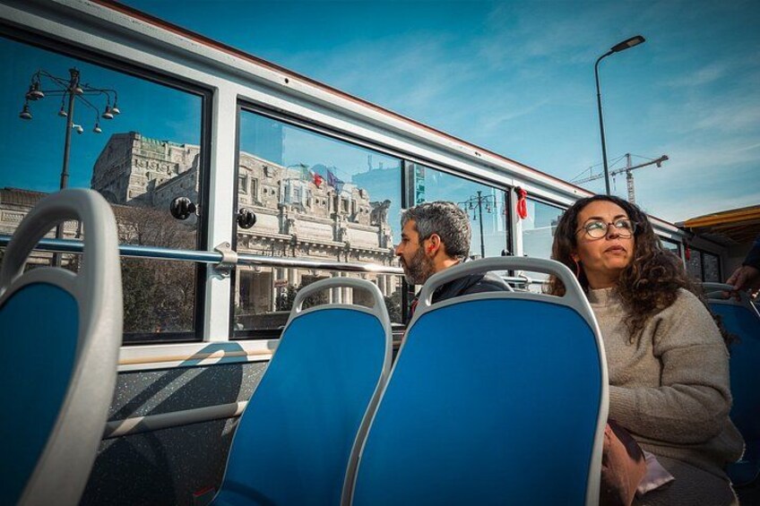 A bus interior with blue seats and a large window. 3