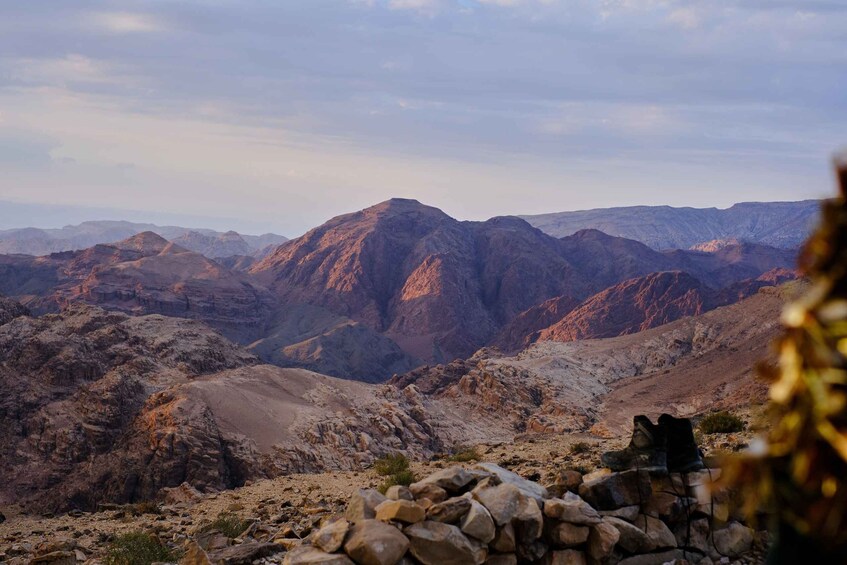A rugged mountain landscape with rocky terrain and distant peaks. 3