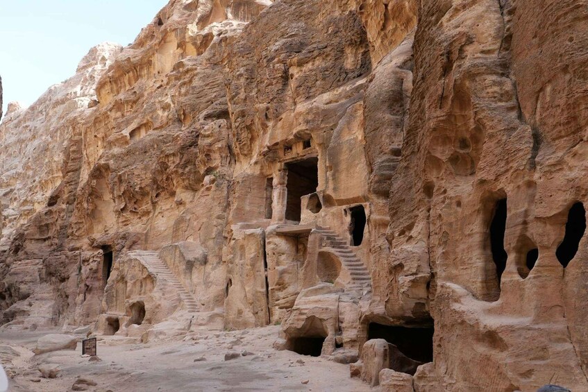 A rock face with carved niches and staircases. 4