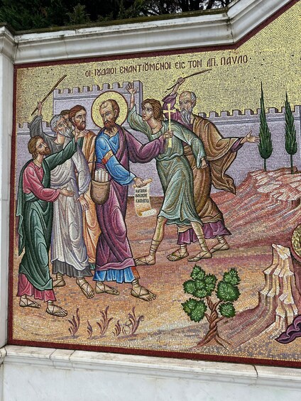 A mosaic with religious figures, a cross, and a tree. 4