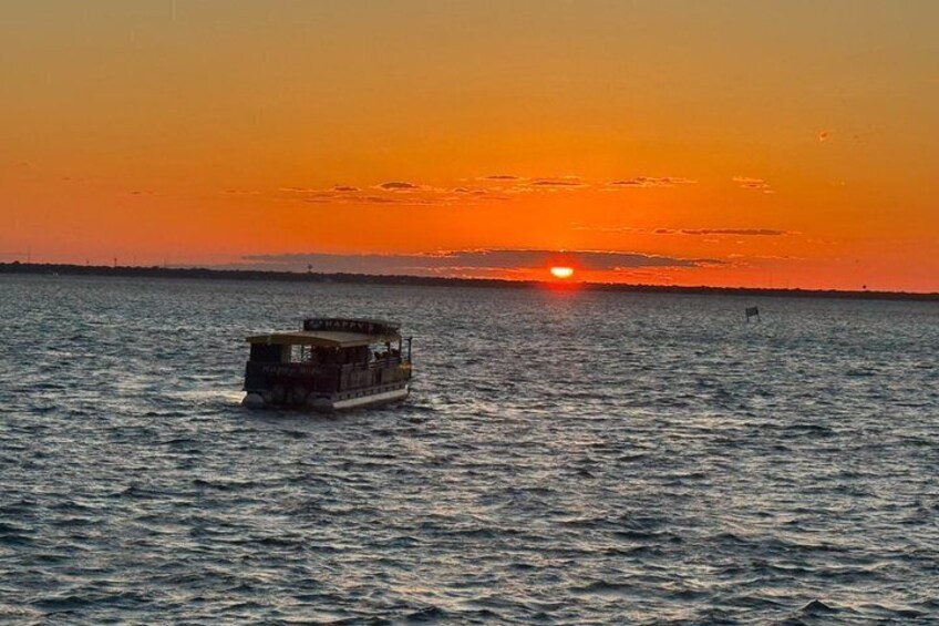 A boat on calm water during sunset. 5