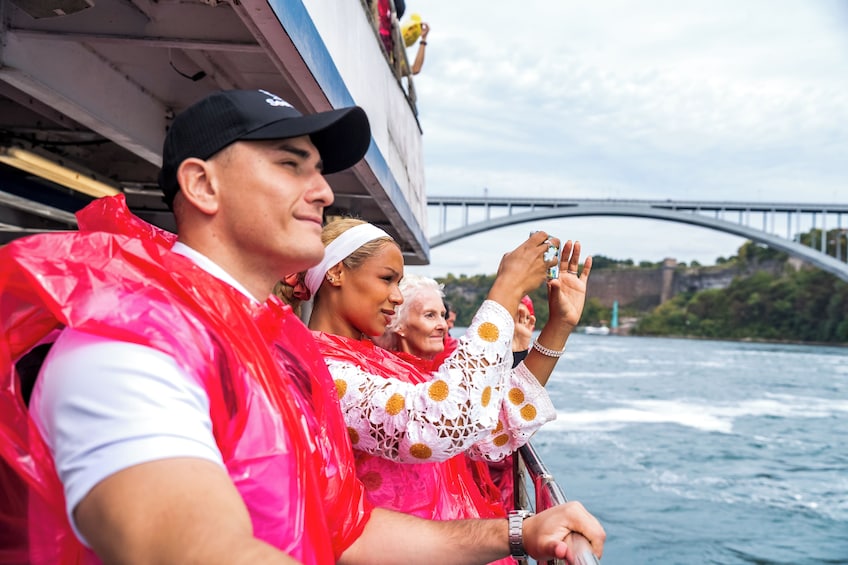 People on a boat with a bridge in the background. 4