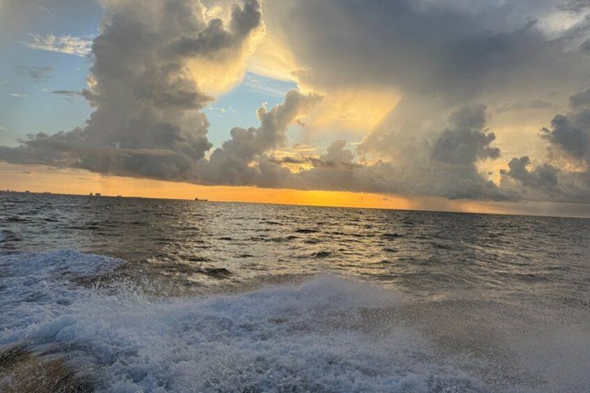 A sunset over the ocean with waves and clouds. 2