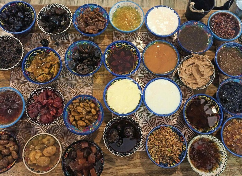 A variety of colorful dishes arranged on a patterned tablecloth. 3