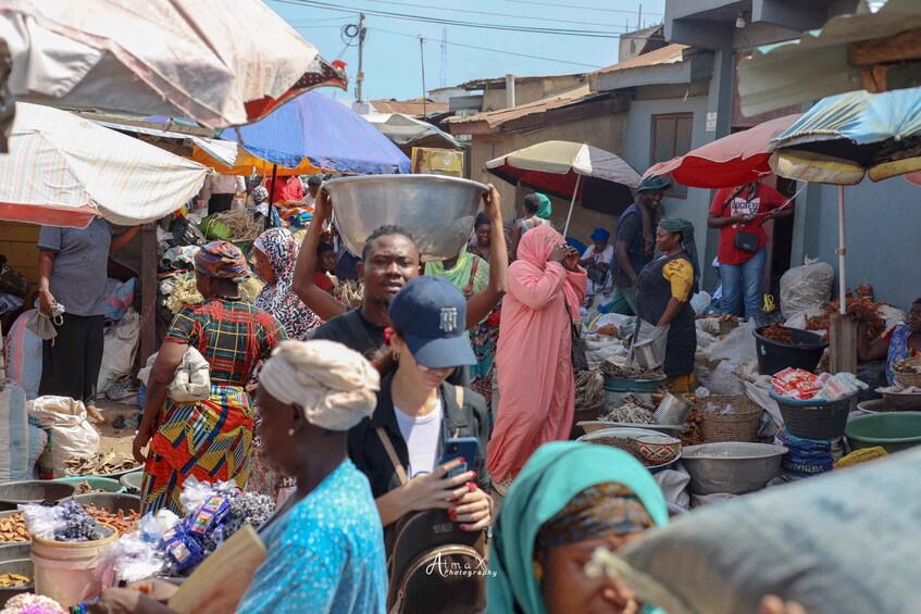 A bustling outdoor market with people carrying goods and engaging in trade. 4