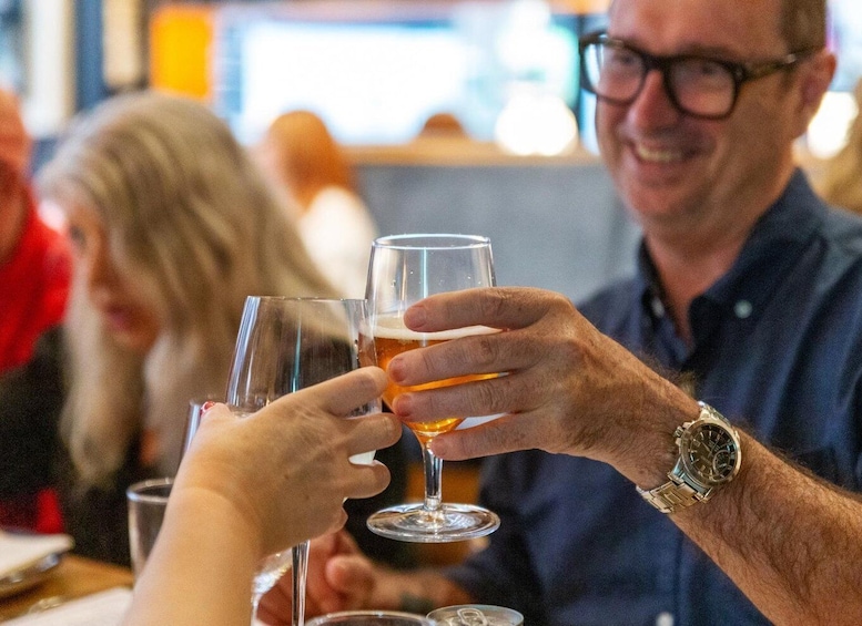 Two people toasting with beer glasses. 3