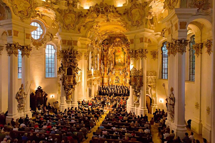 An ornate church interior with a choir and congregation. 2