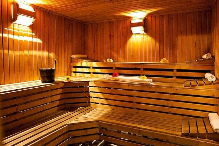 A wooden sauna with benches and a bench seat. 5