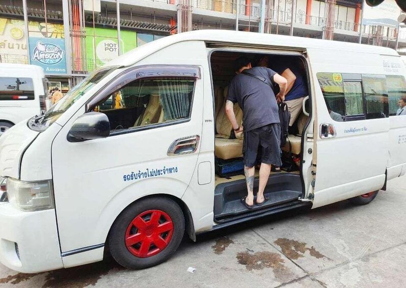 A white van with red wheels parked on a street. 5