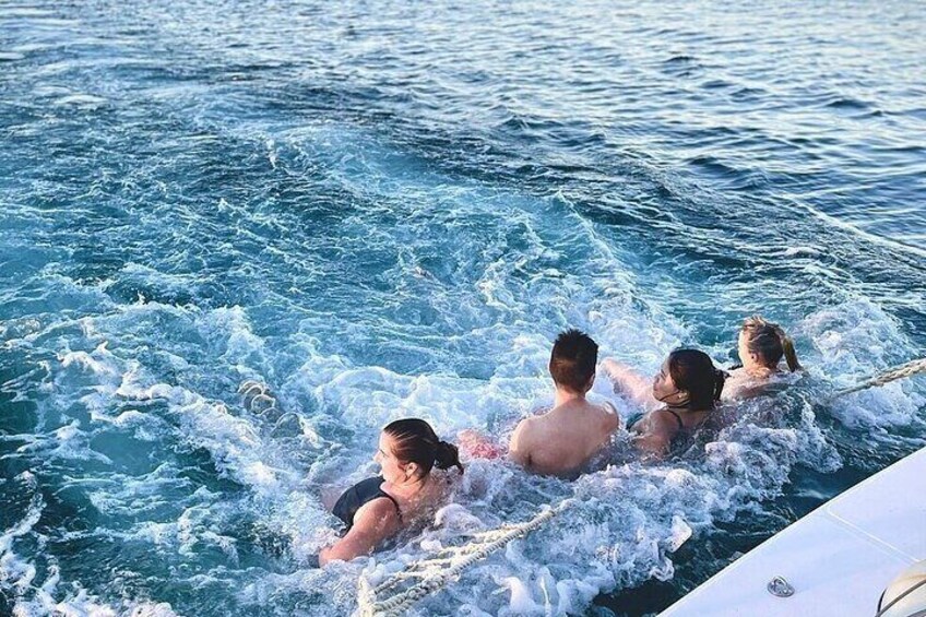 A group of people in a boat on a body of water. 3