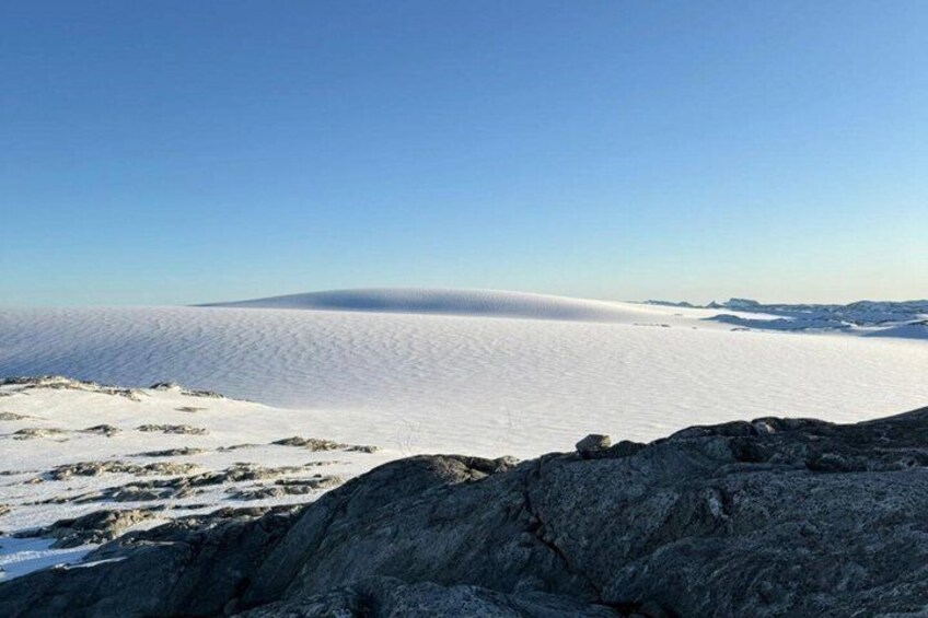 A vast snowy landscape with a clear sky. 5
